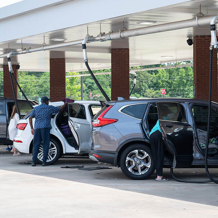 Customers vacuuming cars in the vacuum area